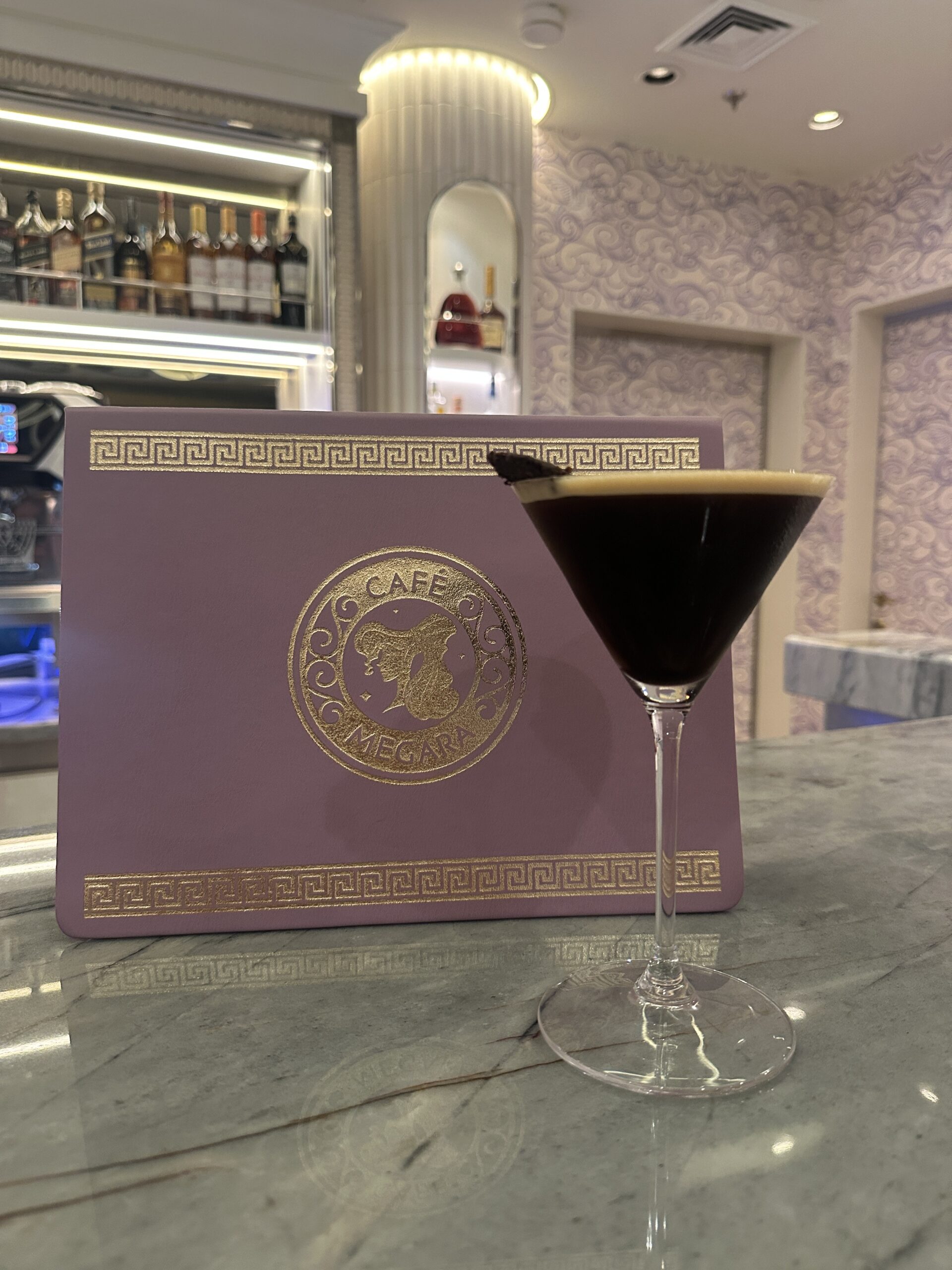 Get a first look at Café Megara on the Disney Destiny, a cozy Hercules-themed café offering coffee, cocktails, and Disney magic.