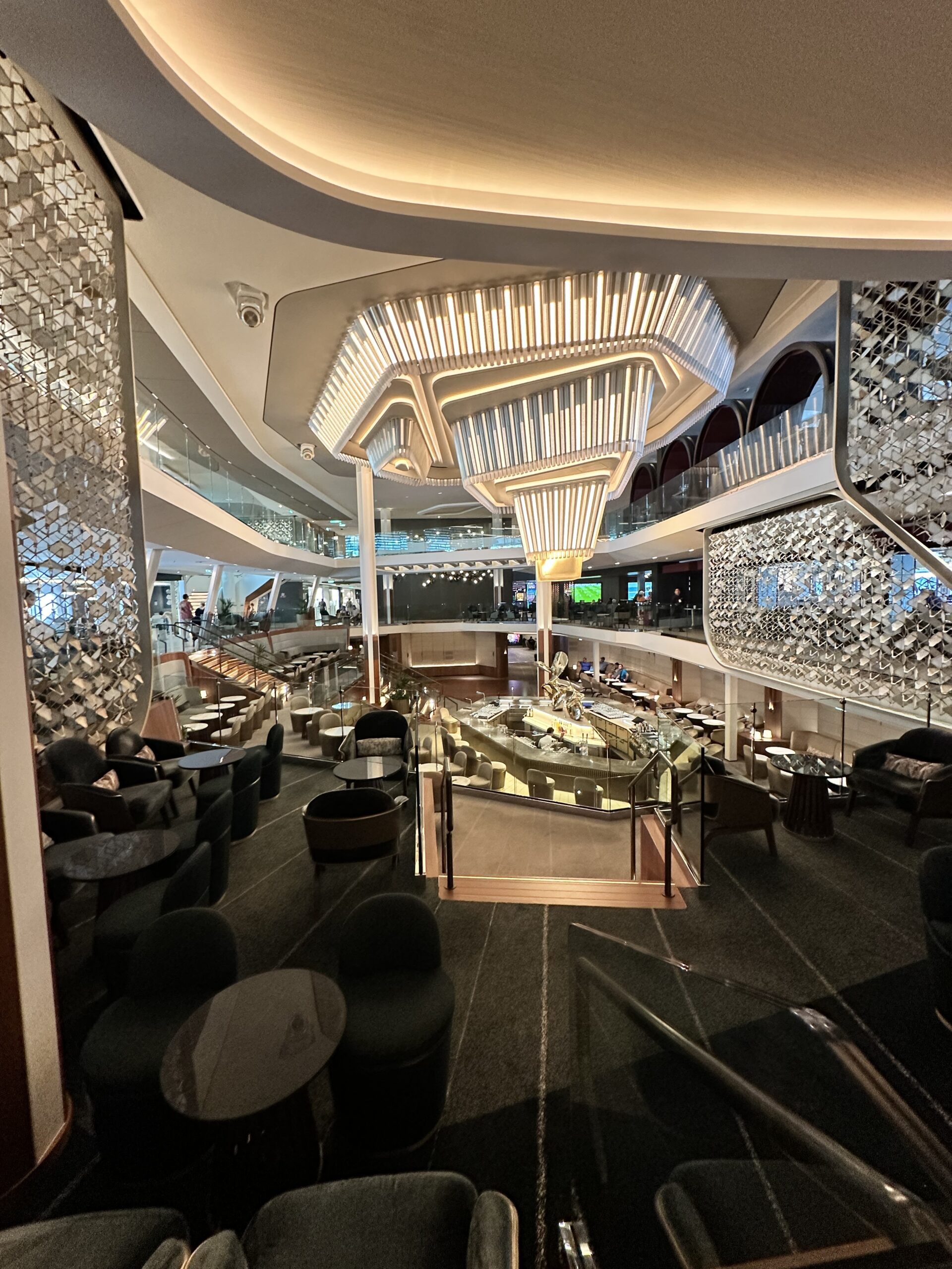 The Grand Plaza on Celebrity Ascent Open view of Grand place with chandelier and martini bar